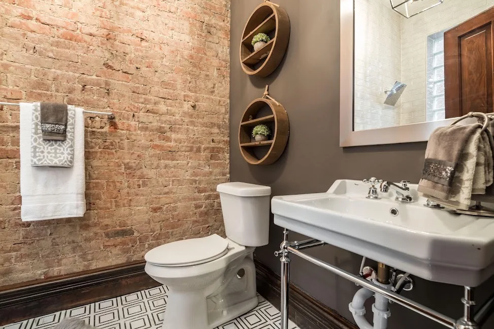 Bathroom with exposed brick feature wall