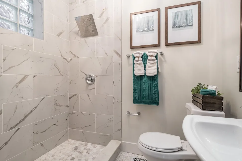 Bathroom finished with marble-effect tile and modern vanity
